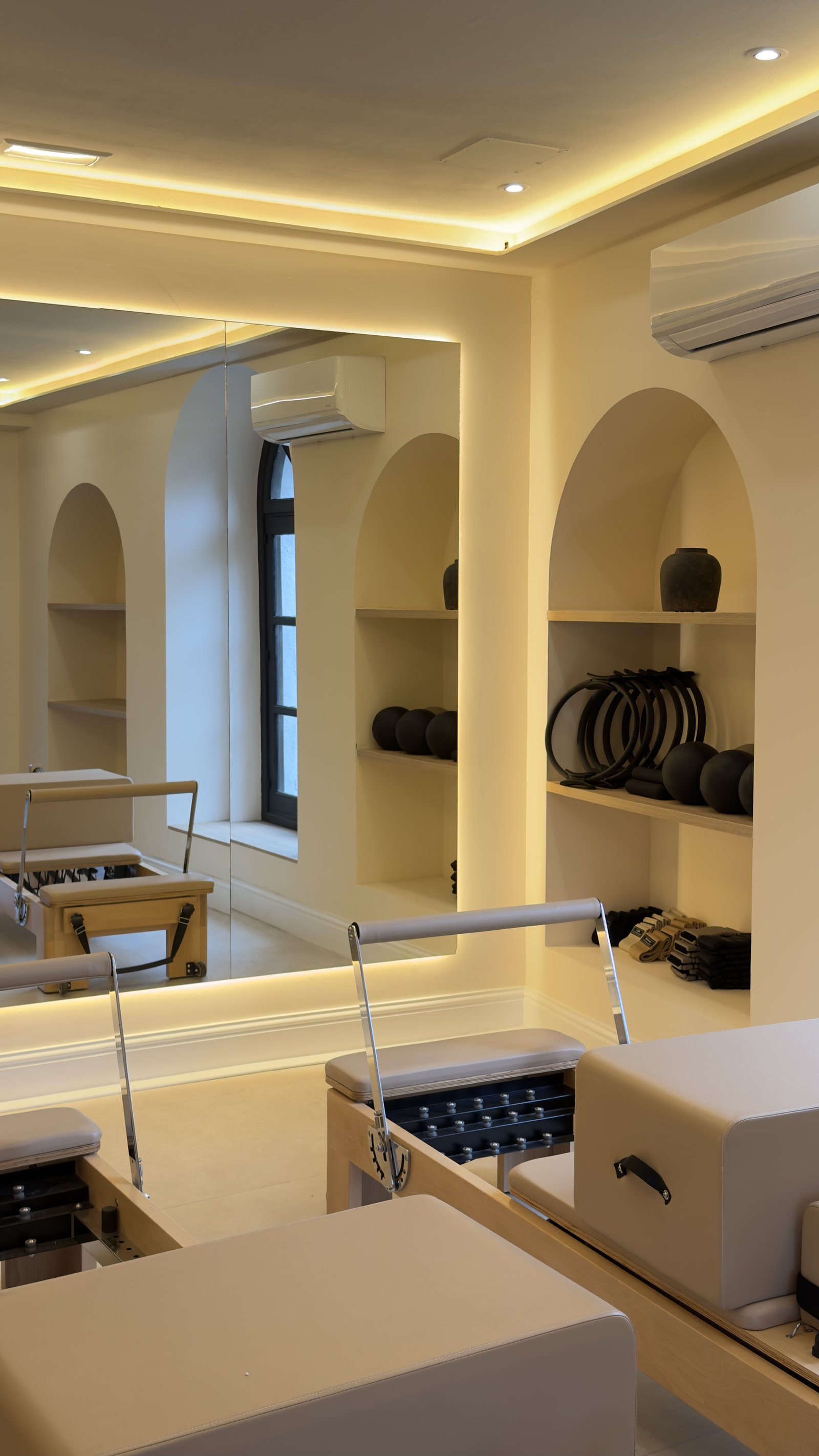 Pureform studio interior with arched alcoves and reformer Pilates equipment